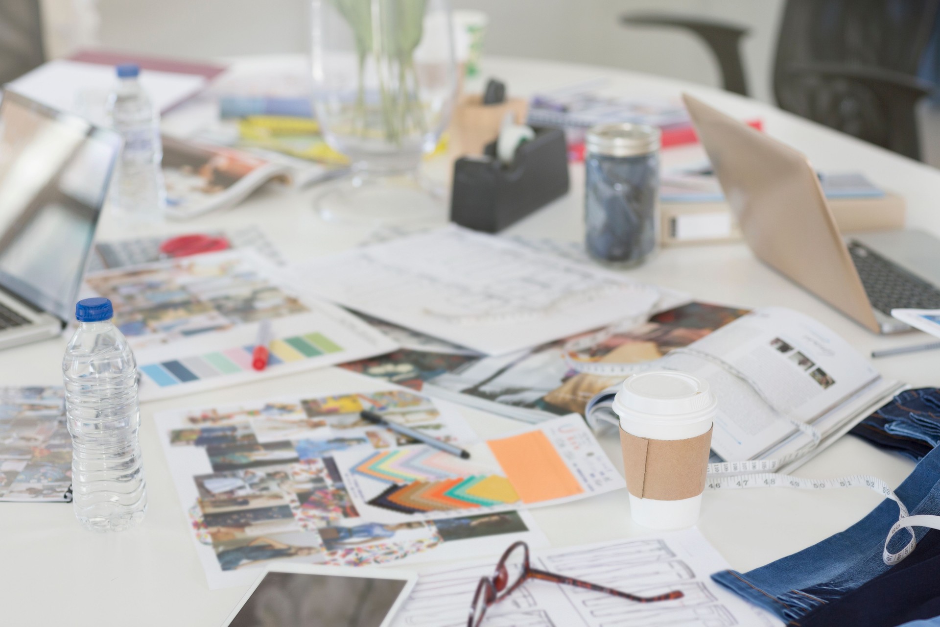 Proofs, swatches and paperwork on conference table
